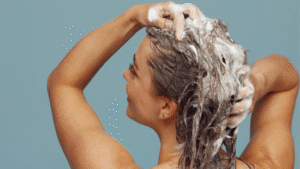 Mujer lavando el cabello con champú con ketoconazol